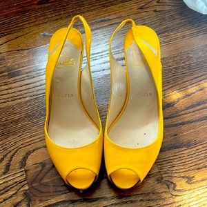 Louboutin yellow patent sling back heels.